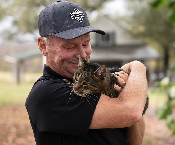 Warriors' Best Friend founder, Joe Jeffers, holding a cat.
