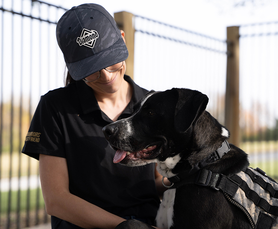 A Warriors' Best Friend trainer with a dog.
